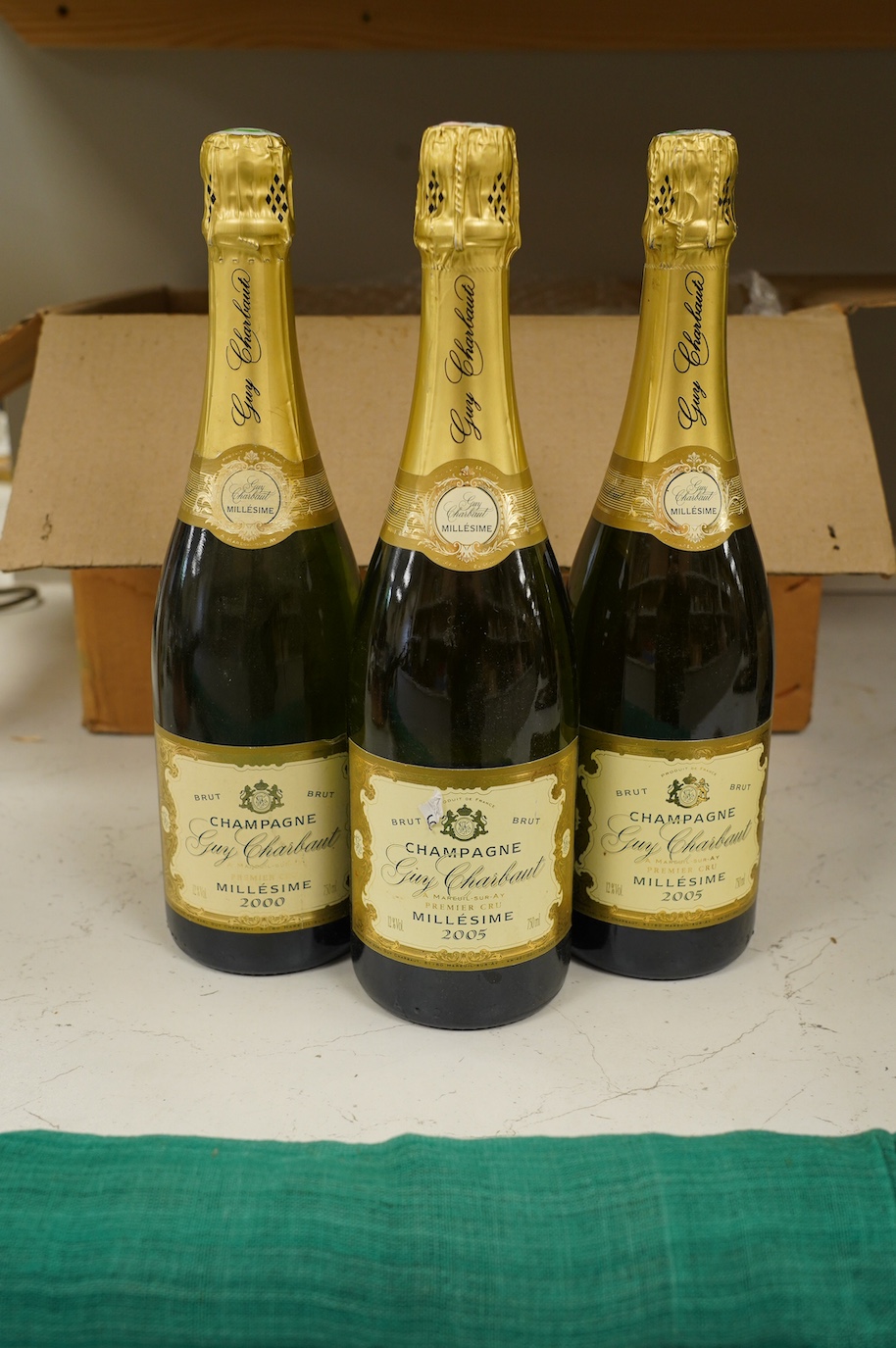 Twelve bottles of Guy Charbaut champagne (8 x 2000 and 4 x 2005). Condition - good